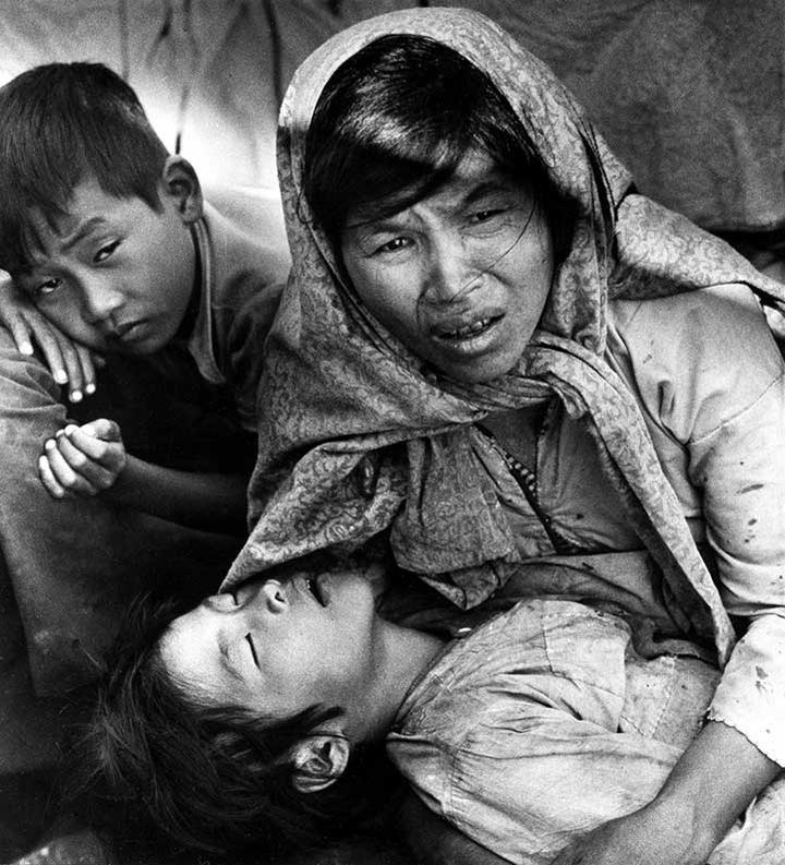 A Vietnamese mother, Mrs. Nguyen Thi Yen, holds her sick child as she pleads help from a fishing boat carrying her and 48 other refugees as they arrive at Khlong Yai, a village 220 miles southeast of Bankgkok, Thailand.