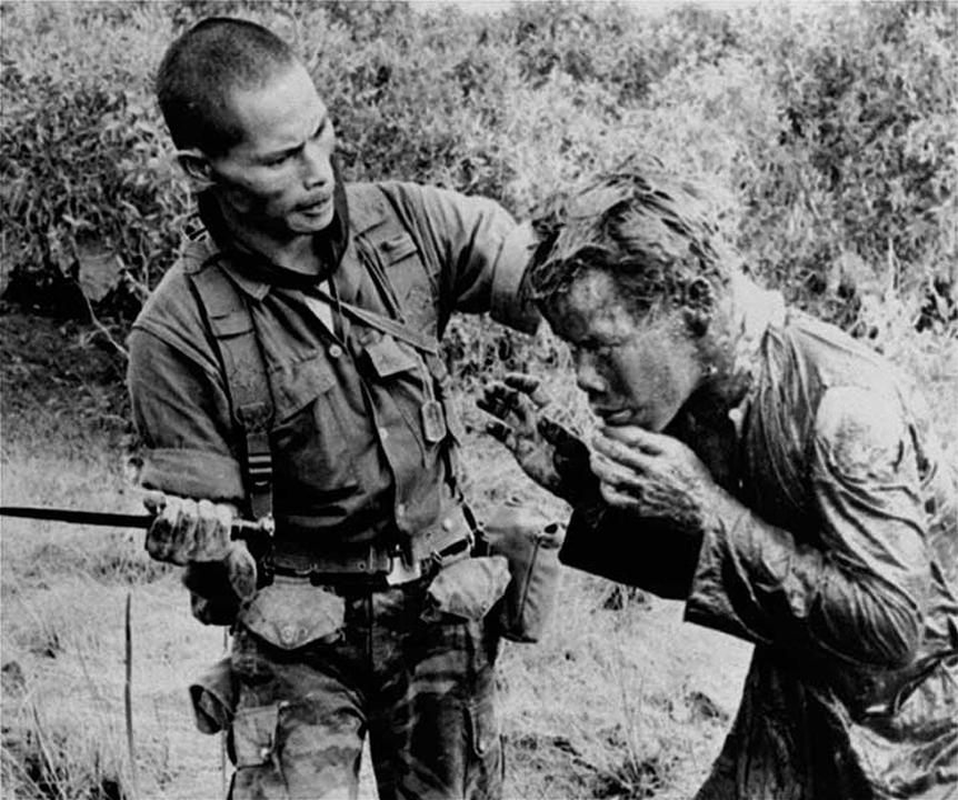 A South Vietnamese ranger uses the end of a dagger to administer punishment to a South Vietnamese farmer for allegedly supplying government troops with wrong information on Communist guerrillas.